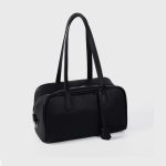 A black pebbled vegan leather Boston bag with long shoulder straps, a top zipper, and a matching leather clochette. Additional product view 4.