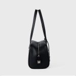 A black pebbled vegan leather Boston bag with long shoulder straps, a top zipper, and a matching leather clochette. Additional product view 5.