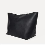 A slouchy black pebbled vegan leather tote with long thin shoulder straps and an open trapezoid silhouette. Additional product view 7.