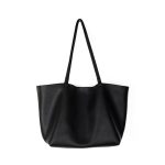 A slouchy black pebbled vegan leather tote with long thin shoulder straps and an open trapezoid silhouette.