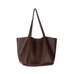 A slouchy black pebbled vegan leather tote with long thin shoulder straps and an open trapezoid silhouette. Additional product view 2.