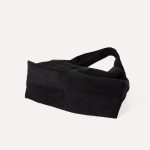 A matte black faux suede hobo bag with a slouchy triangular silhouette and a wide integrated shoulder strap. Additional product view 7.