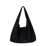 A matte black faux suede hobo bag with a slouchy triangular silhouette and a wide integrated shoulder strap.