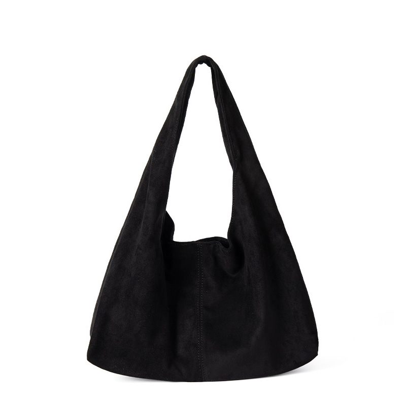 A matte black faux suede hobo bag with a slouchy triangular silhouette and a wide integrated shoulder strap.