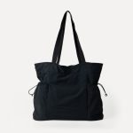 A black crinkled nylon shopper tote with webbing straps and a mid-body drawstring that creates a ruched gathered shape. Additional product view 8.