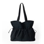 A black crinkled nylon shopper tote with webbing straps and a mid-body drawstring that creates a ruched gathered shape.
