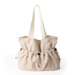 A black crinkled nylon shopper tote with webbing straps and a mid-body drawstring that creates a ruched gathered shape. Additional product view 3.