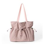 A black crinkled nylon shopper tote with webbing straps and a mid-body drawstring that creates a ruched gathered shape. Additional product view 4.