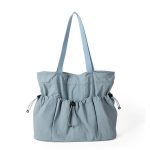 A black crinkled nylon shopper tote with webbing straps and a mid-body drawstring that creates a ruched gathered shape. Additional product view 5.