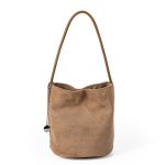 A small black faux suede bucket bag with a thin tubular strap and a silver chain charm at the strap base. Additional product view 2.