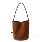 A small black faux suede bucket bag with a thin tubular strap and a silver chain charm at the strap base. Additional product view 3.