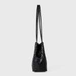 A black woven vegan leather bucket shoulder bag with matching tubular straps and a tight diagonal intrecciato weave. Additional product view 6.