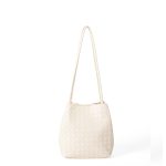 A black woven vegan leather bucket shoulder bag with matching tubular straps and a tight diagonal intrecciato weave. Additional product view 3.