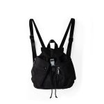 A small black nylon backpack with a drawstring flap, translucent buckle, angled front pocket, and webbing shoulder straps.