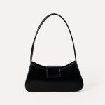 A cognac brown vegan leather baguette shoulder bag with a small front bow on the flap and a slim underarm strap. Additional product view 7.