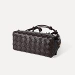 A dark espresso brown woven vegan leather mini dome crossbody with thin knotted cord straps and a gold-tone zipper. Additional product view 9.