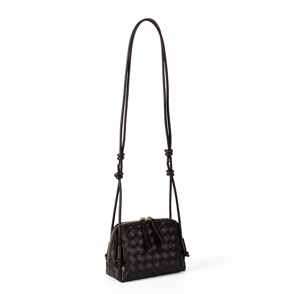 A dark espresso brown woven vegan leather mini dome crossbody with thin knotted cord straps and a gold-tone zipper.