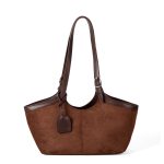 A black faux suede tote with a scooped top, smooth vegan leather trim, and adjustable buckled shoulder straps. Additional product view 3.