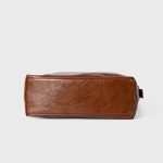 A glossy black crinkled vegan leather crescent underarm bag with a knotted side strap and a silver zipper pull. Additional product view 7.