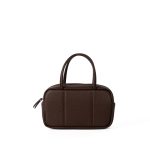 A boxy black pebbled vegan leather mini Boston bag with rolled top handles and long zipper pulls. Additional product view 3.