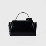 A glossy black structured vegan leather handbag with a thin top handle and a silver cross-bar toggle clasp. Additional product view 7.