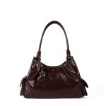 A shiny black vegan leather hobo shoulder bag with a row of silver studs, side flap pockets, and a hanging heart charm. Additional product view 2.