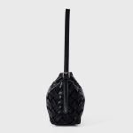 A black basketweave vegan leather crescent underarm bag with a slim adjustable strap and a silver top zipper. Additional product view 7.