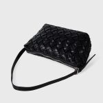 A black basketweave vegan leather crescent underarm bag with a slim adjustable strap and a silver top zipper. Additional product view 9.