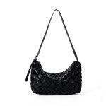 A black basketweave vegan leather crescent underarm bag with a slim adjustable strap and a silver top zipper.