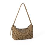 A black basketweave vegan leather crescent underarm bag with a slim adjustable strap and a silver top zipper. Additional product view 4.