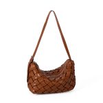 A black basketweave vegan leather crescent underarm bag with a slim adjustable strap and a silver top zipper. Additional product view 5.