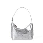A glossy black vegan leather crescent bag covered in small silver studs, with an adjustable strap and top zipper. Additional product view 3.