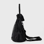 A black nylon drawstring backpack with ruffled cinch opening, side pockets, webbing straps, and a small top handle. Additional product view 5.