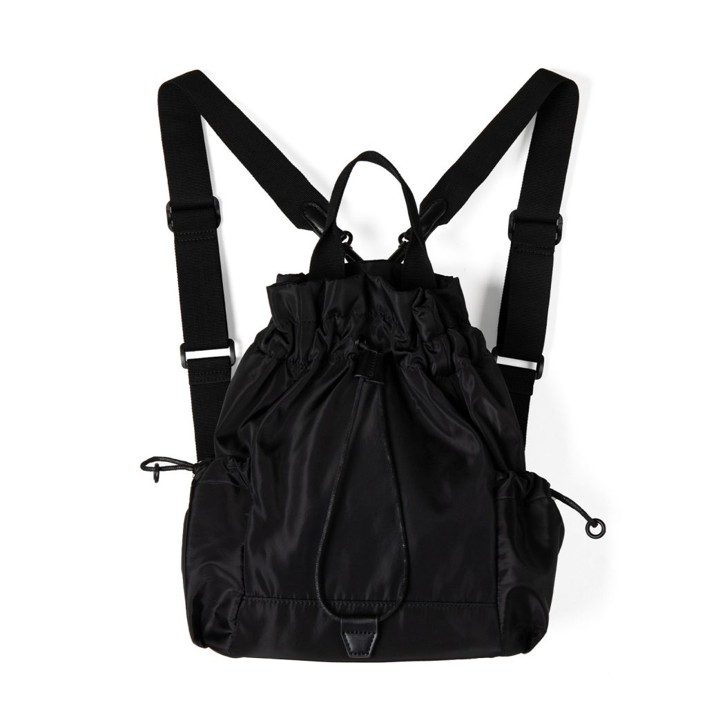 A black nylon drawstring backpack with ruffled cinch opening, side pockets, webbing straps, and a small top handle.