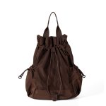 A black nylon drawstring backpack with ruffled cinch opening, side pockets, webbing straps, and a small top handle. Additional product view 4.