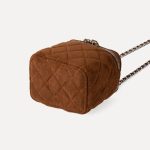 A small black quilted faux suede vanity box bag with dual silver zippers and a chain strap interwoven with black cord. Additional product view 9.