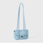 A dusty pink pebbled vegan leather baguette with a silver turn-lock flap and two long thin shoulder straps. Additional product view 6.