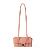 A dusty pink pebbled vegan leather baguette with a silver turn-lock flap and two long thin shoulder straps. Additional product view 4.