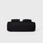 A black polyester rectangular shoulder bag with two buttoned cargo pockets edged in white lace and a top zipper. Additional product view 7.