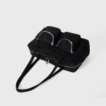 A black polyester rectangular shoulder bag with two buttoned cargo pockets edged in white lace and a top zipper. Additional product view 8.