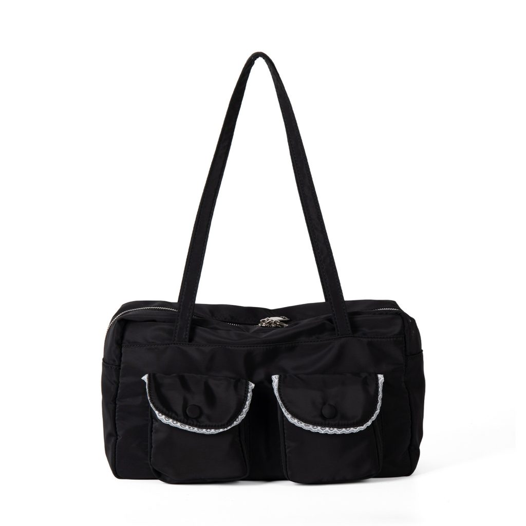 A black polyester rectangular shoulder bag with two buttoned cargo pockets edged in white lace and a top zipper.