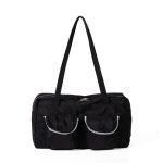 A black polyester rectangular shoulder bag with two buttoned cargo pockets edged in white lace and a top zipper.