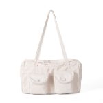 A black polyester rectangular shoulder bag with two buttoned cargo pockets edged in white lace and a top zipper. Additional product view 2.