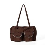 A black polyester rectangular shoulder bag with two buttoned cargo pockets edged in white lace and a top zipper. Additional product view 3.