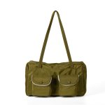 A black polyester rectangular shoulder bag with two buttoned cargo pockets edged in white lace and a top zipper. Additional product view 4.