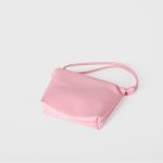A tiny black vegan leather dumpling bag with a ruffled gathered opening and a thin tubular shoulder strap. Additional product view 8.
