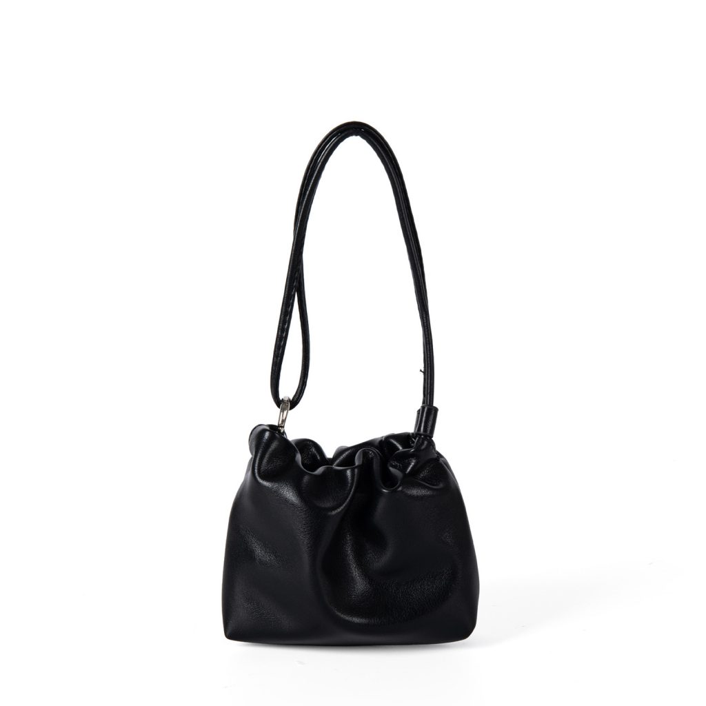 A tiny black vegan leather dumpling bag with a ruffled gathered opening and a thin tubular shoulder strap.
