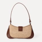 A beige woven canvas baguette with dark brown vegan leather corner patches, a center buckle strap, and a slim shoulder strap. Additional product view 6.