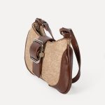 A beige woven canvas baguette with dark brown vegan leather corner patches, a center buckle strap, and a slim shoulder strap. Additional product view 7.