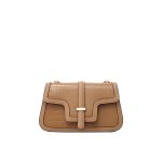 A tan apricot croc-embossed vegan leather flap bag with a stepped geometric flap, center buckle, and gold chain strap.